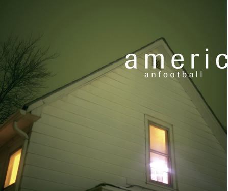 Album cover of American Football by the band American Football. The image features the upper portion of a white suburban house at night, with two warmly lit windows. The sky is a muted greenish hue, and a leafless tree branch extends into the frame. The album title and band name appear in minimalist lowercase white text in the upper right corner.